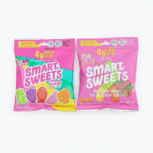 Two bags of Smart Sweets candy. The top bag is purple with lime green and white text, and the bottom bag is pink with green, yellow, and orange graphics.
